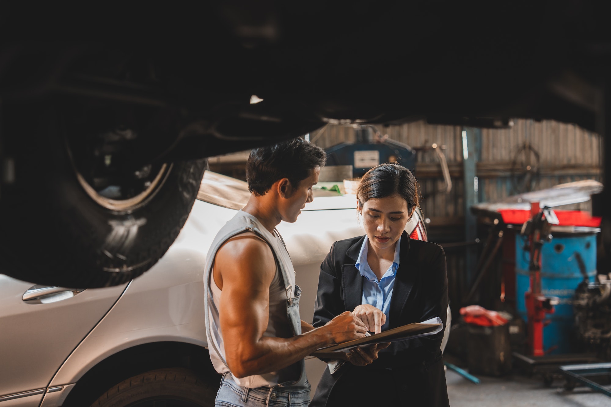 customer making inspection check to a car engine repair occupation job at garage service