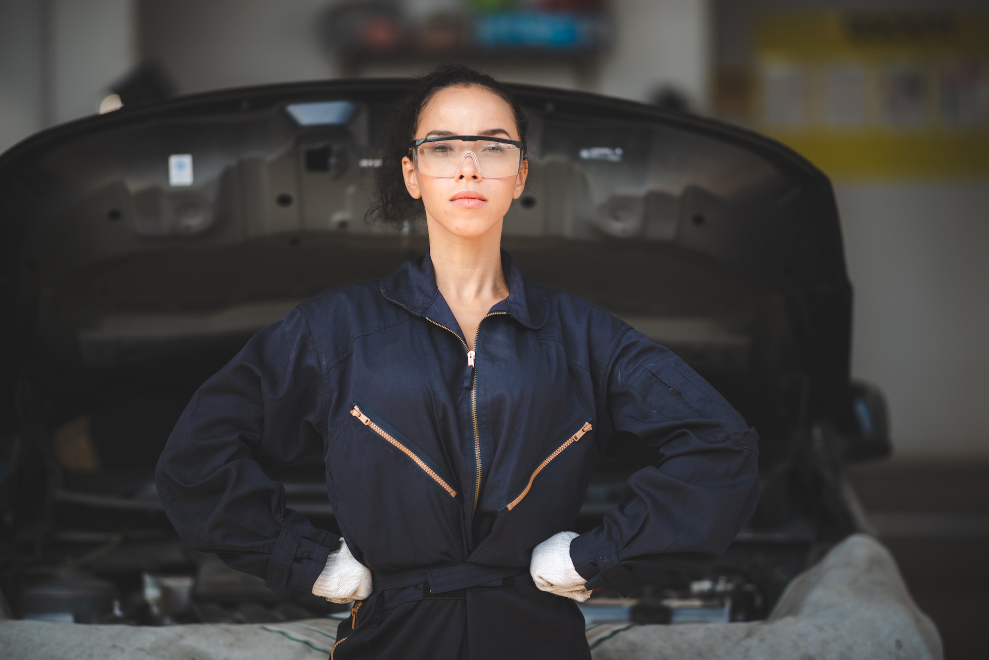 professional African American mechanic woman portrait, auto car repair and service workshop